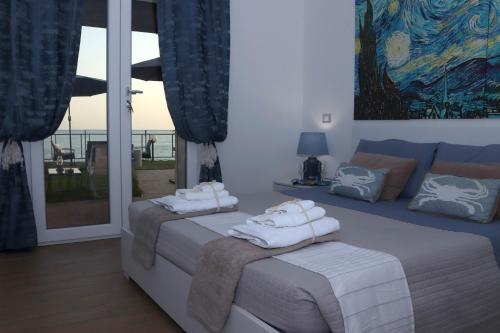a bedroom with two beds with towels on them at Sunset House in Anzio