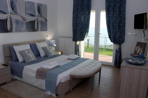 a bedroom with a large bed and a sliding glass door at Sunset House in Anzio