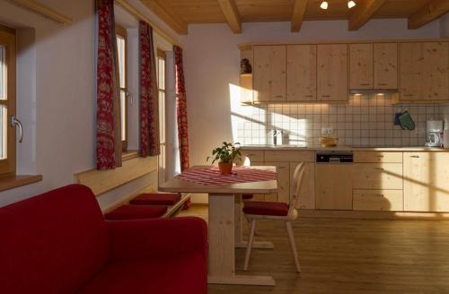 a kitchen with a table and chairs in a room at Appartments Jagerhof in Braies