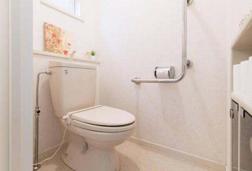 a white bathroom with a toilet and a shower at City Garden - Vacation STAY 87278 in Fukuoka