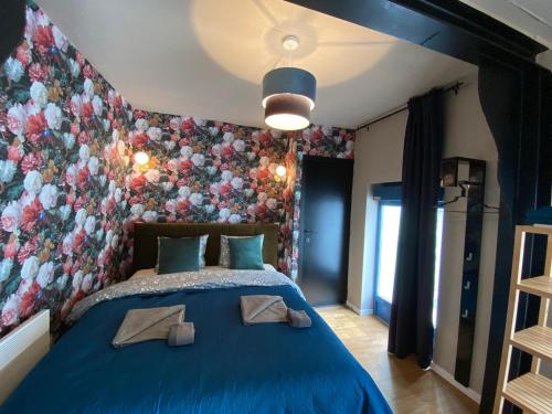 a bedroom with a blue bed with towels on it at Luxury Suites in Antwerp