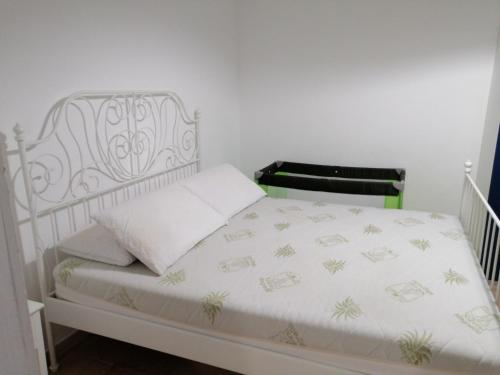 a bedroom with a white bed with a white bedspread at Casa Maris in Santo Stefano di Camastra