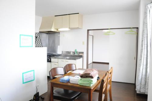 a kitchen with a wooden table and a dining room at Ark City Asahikawa - Vacation STAY 8531 in Asahikawa