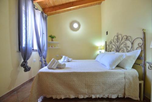 a bedroom with a bed with two towels on it at IzzHome Nora Beach in Pula