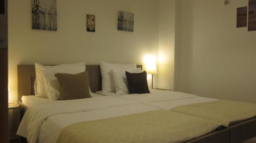 a bedroom with two beds with white sheets and pillows at Viola in Skradin