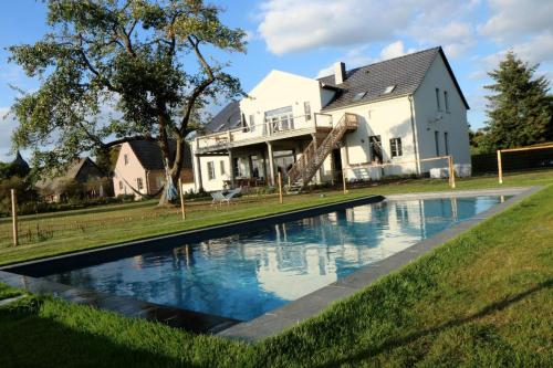 una casa con piscina frente a una casa en Cottage, en Buchholz