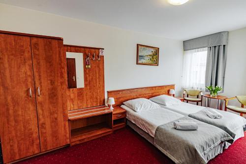 a bedroom with a large bed and a large cabinet at Panorama_SPA in Trzęsacz