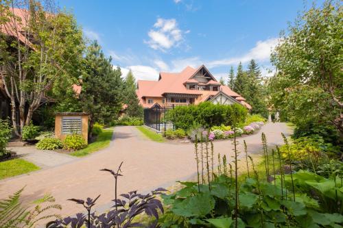 a house with a driveway in front of it at Sunpath by Outpost Whistler in Whistler