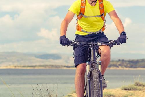 a man riding a bike on the beach at Studio apartment Miramare breakfast and parking in Rijeka