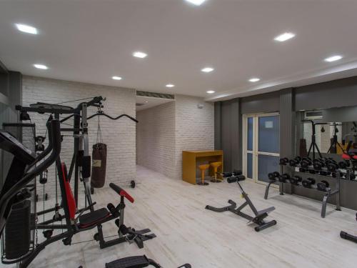 a gym with treadmills and exercise bikes in a room at Address Residence Suite Hotel in Antalya