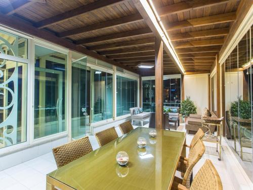 an outdoor patio with a wooden table and chairs at Address Residence Suite Hotel in Antalya