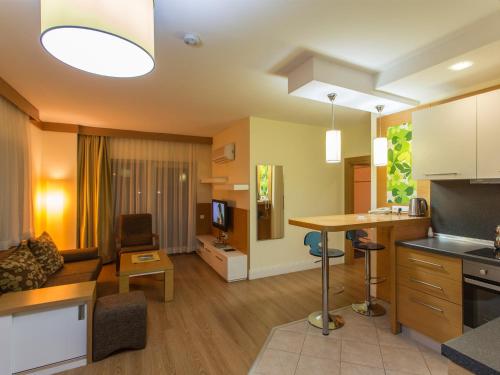 a living room with a couch and a table at Address Residence Suite Hotel in Antalya
