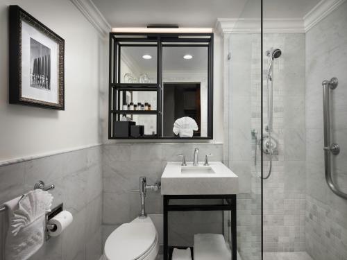 a bathroom with a toilet and a sink and a shower at La Valencia Hotel in San Diego