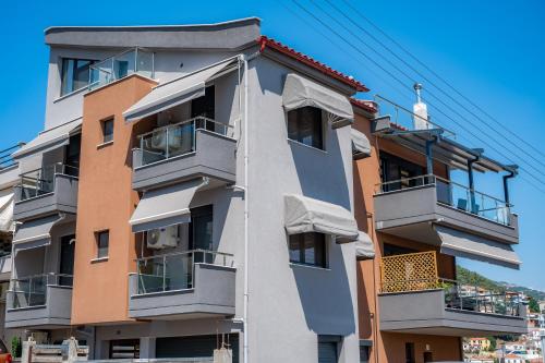 a tall building with balconies on the side of it at DNS Apartment in Kavala