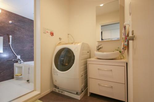 a washing machine in a bathroom with a sink at Room 301 - Vacation STAY 86506 in Fukuoka