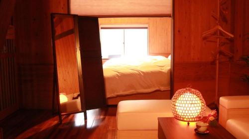 a bedroom with a bed and a mirror at Nagoya - House - Vacation STAY 7563 in Nagoya