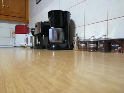 a kitchen counter with a coffee maker on a wooden floor at Rodomelo House with Terrace - 4 Bedrooms in Leonidion