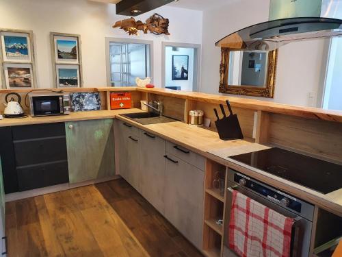 a kitchen with a sink and a stove top oven at Kunstwerk AppARTement in Sankt Michael im Lungau