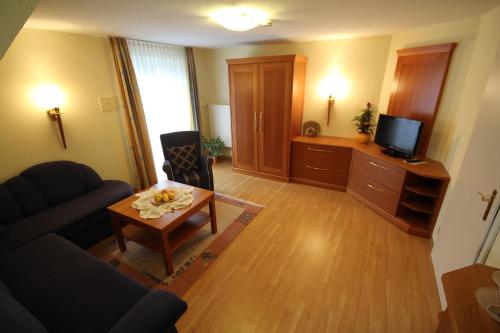 a living room with a couch and a table at Hotel Cebulj in Bad Wörishofen