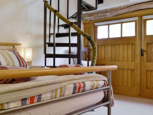 a bedroom with two bunk beds and a staircase at Ty-Gwyn in Abergavenny