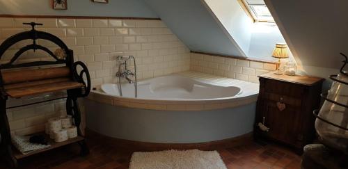 a bathroom with a bath tub in a attic at Dom Mazurski Mącze in Ełk