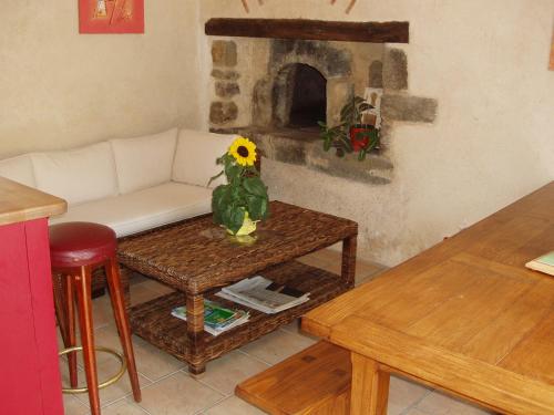 a living room with a couch and a fireplace at Gîte de La Porte du Parc in Les Iffs