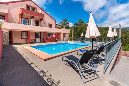 a villa with a swimming pool and a house at Quinta Frizado in Prazeres