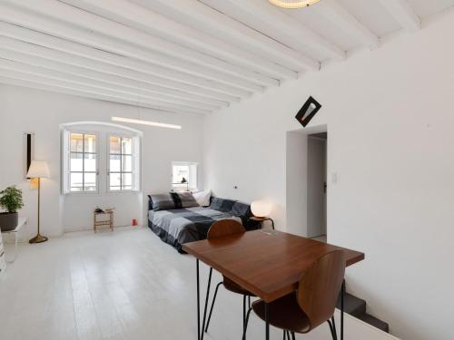 a living room with a bed and a wooden table at Holiday Home in Avignon next to the City Centre in Avignon