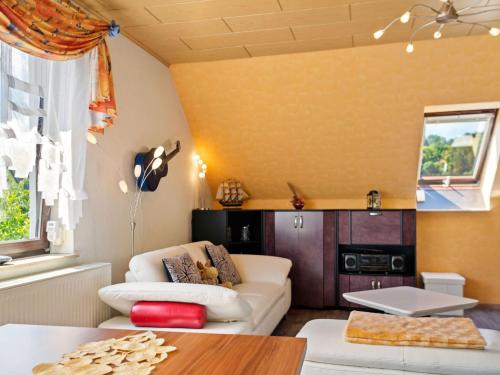 a living room with a couch and a table at Apartment with garden view in the Erzgebirge in Pöhla