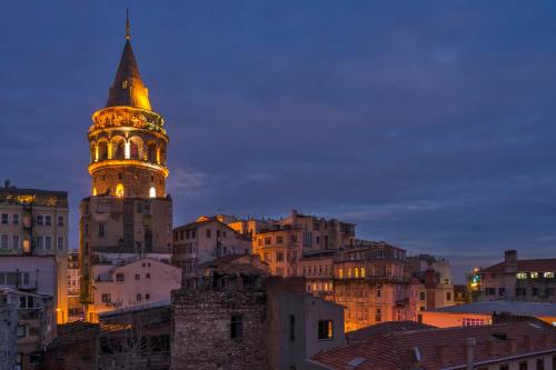 a tall building with a clock tower in a city at Corner Garden Hotel in Istanbul