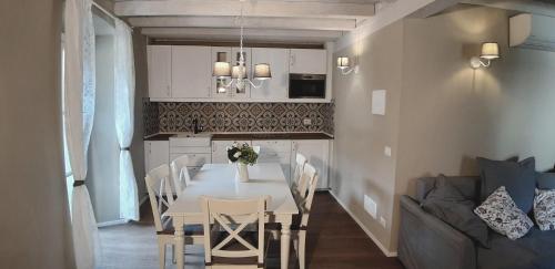 a kitchen and dining room with a table and chairs at DomasHome in Domaso