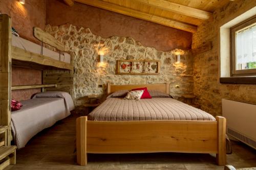 a bedroom with two beds in a log cabin at b&b le nosare in Bosco Chiesanuova