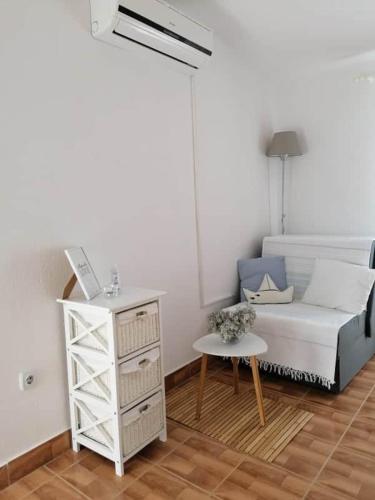a living room with a white couch and a table at Apartment Krmpotić in Vir