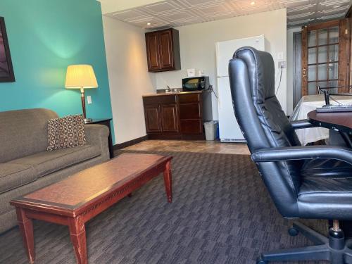 a living room with a couch and a chair at Travelodge by Wyndham Miramichi New Brunswick in Miramichi
