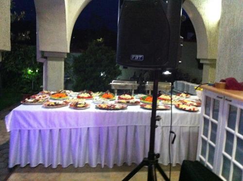 a table with plates of food on it with a camera at Sunny House in Skopje