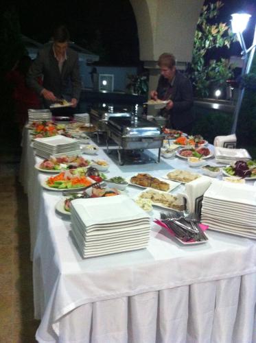 a long table with plates of food on it at Sunny House in Skopje