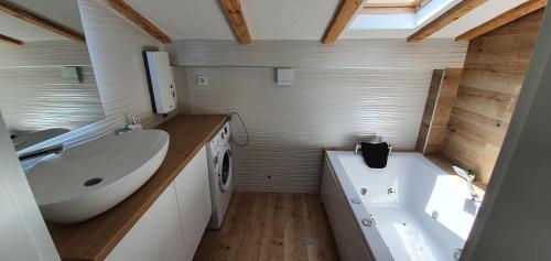 a bathroom with a sink and a tub and a toilet and a sink at Villa Passage in Ohrid