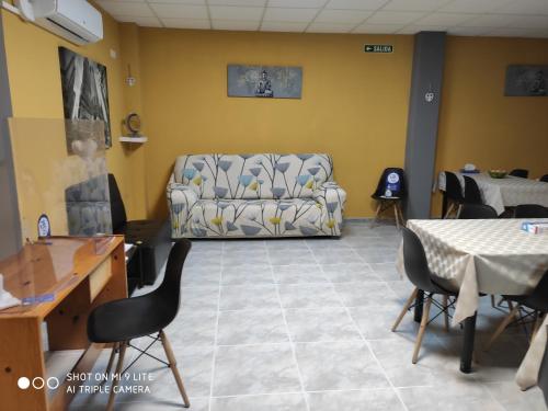 
a living room filled with furniture and a tv at Arraigos in Melide
