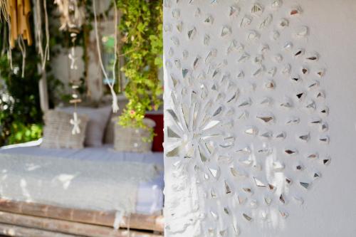 a white curtain with birds on it on a table at Casa Klod Ibiza in Ibiza Town