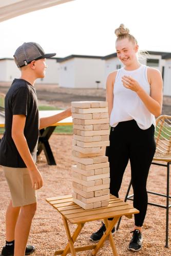 two people standing next to a stack of bricks on a table at Zion Wildflower Resort in Virgin