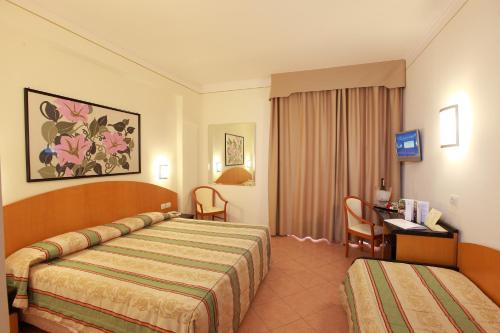 Postel nebo postele na pokoji v ubytování Hotel Caravel