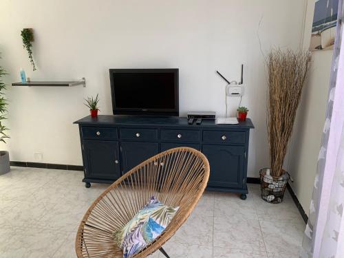 a black dresser with a television on top of it at Apartamentos Alberto in Morro del Jable