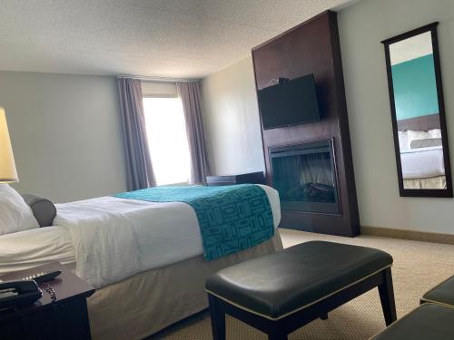 a hotel room with a bed and a fireplace at Travelodge by Wyndham Miramichi New Brunswick in Miramichi