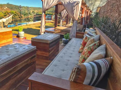 a patio with couches and pillows at Hotel Recanto do Ouro in Ouro Preto