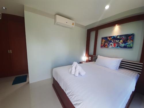 a bedroom with a bed with a towel on it at CC Beach Resort in Khanom