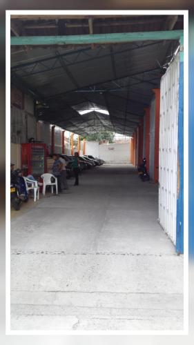 an empty building with people sitting on chairs in it at HOTEL CASA BLANCA BUGA in Buga