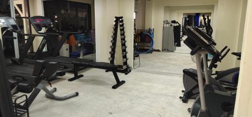 a gym with several tread machines in a room at โฮมสเตย์ เมืองไทยฟิตเนส อารีนา in Ban Bo Nam