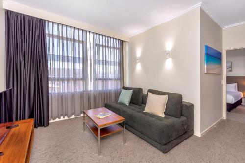 a living room with a couch and a table at New Haus by Hougoumont Hotel, former Bannister 22 in Fremantle