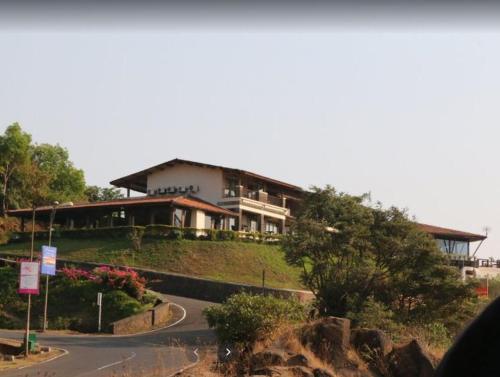 a house on a hill with a road in front of it at Ekaant The Retreat in Lavasa