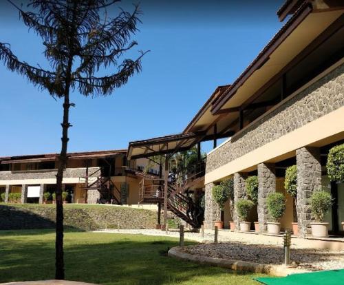 a building with a tree in front of it at Ekaant The Retreat in Lavasa